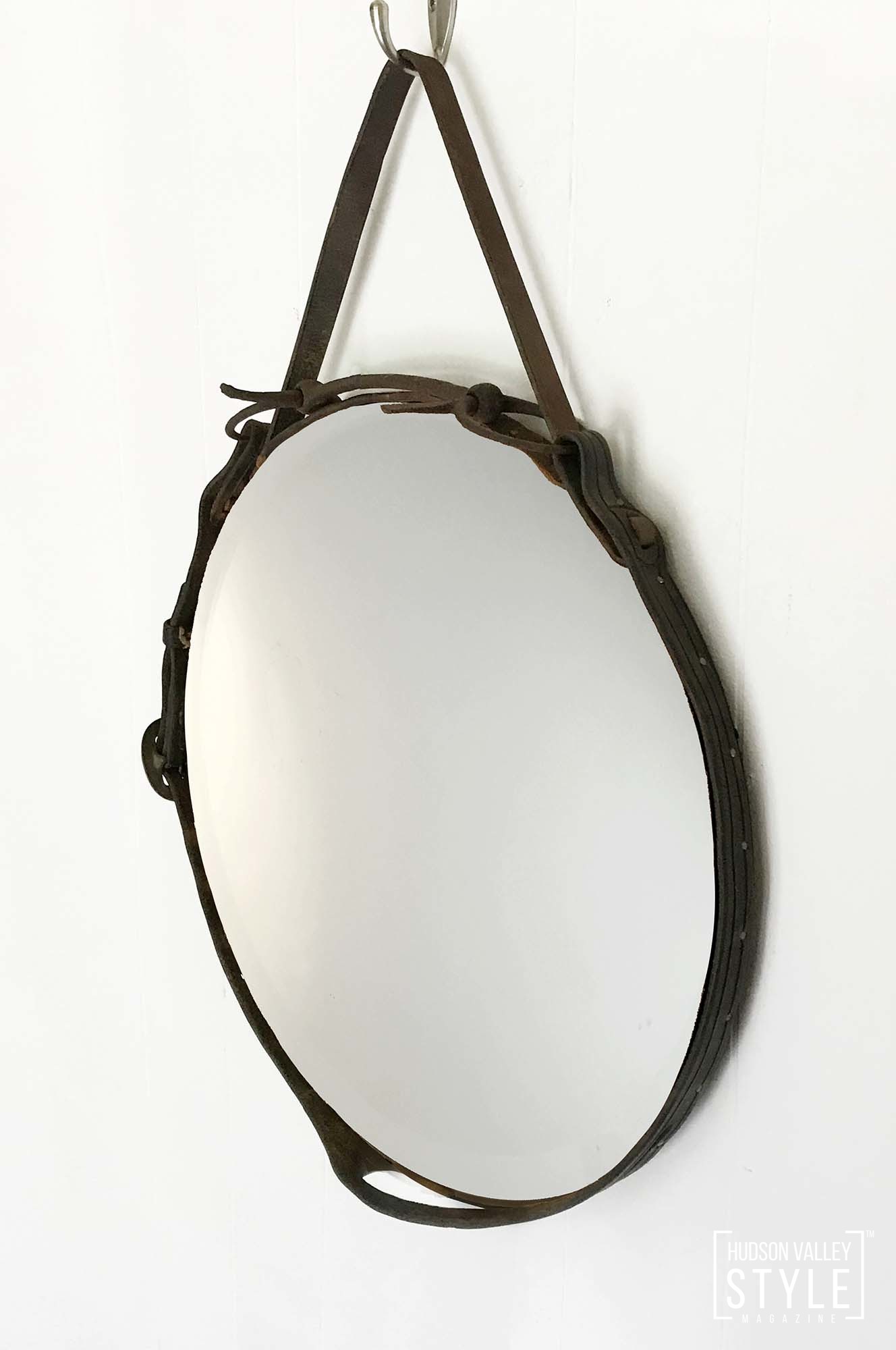 Half-Cheek Curb Bit Equestrian Leather Mirror Hand-tacked vintage bridle leather found in Upstate New York. Mirror hangs from a black iron half-cheek curb horse bit. Dimensions: 16.5” diameter x 1.25” deep. Snaffle bit cheek pieces extend approximately 2.5” from the front of the mirror frame. Leather hanging strap extends approximately 4.5" from the top of the mirror frame. $155